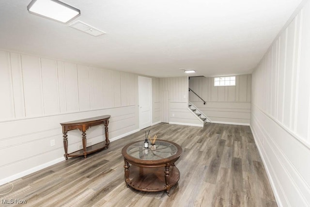 below grade area featuring stairway and wood finished floors