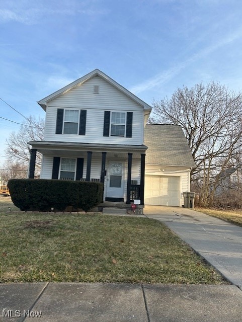 traditional-style home with an attached garage, a front yard, covered porch, and driveway