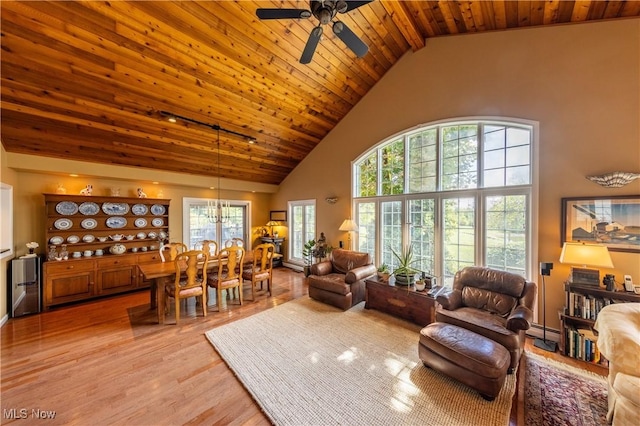 living room featuring high vaulted ceiling, ceiling fan with notable chandelier, a baseboard heating unit, light wood-style floors, and wood ceiling