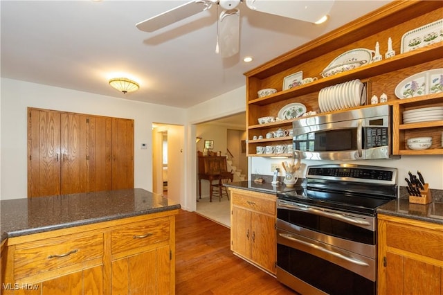 kitchen with brown cabinets, a ceiling fan, open shelves, dark wood-style floors, and stainless steel appliances