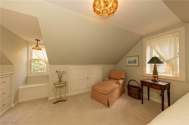 living area featuring light colored carpet, baseboards, and vaulted ceiling