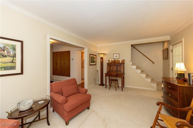 sitting room featuring baseboards, light colored carpet, ornamental molding, and stairs