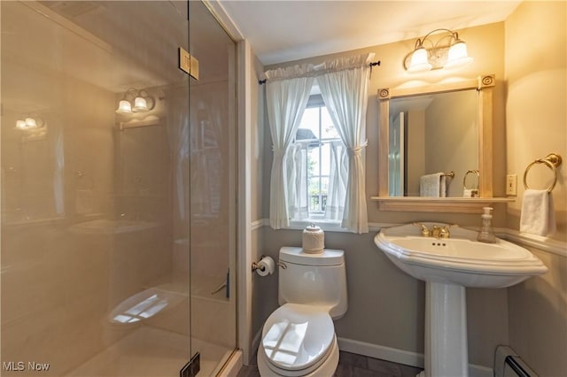 full bathroom featuring a baseboard radiator, baseboards, toilet, and a shower stall