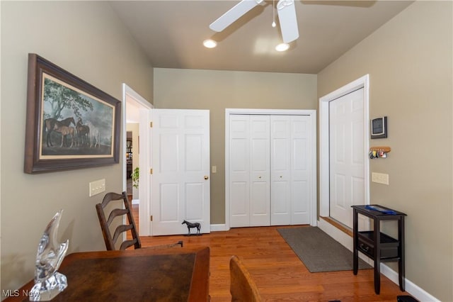 home office with baseboards, a ceiling fan, and wood finished floors