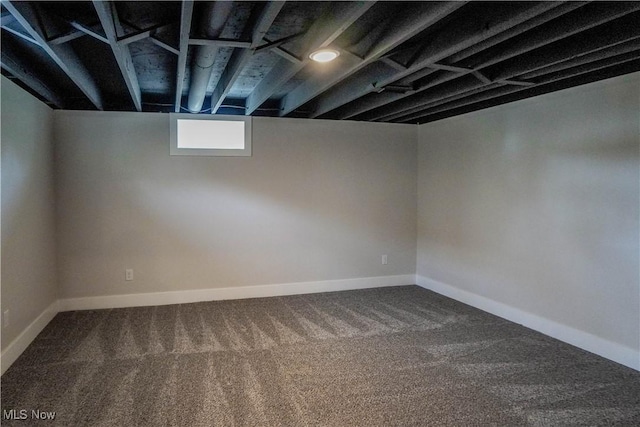 basement featuring baseboards and carpet