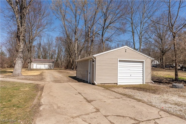 detached garage featuring concrete driveway