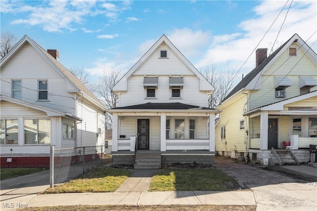 view of front of home with a porch and roof with shingles