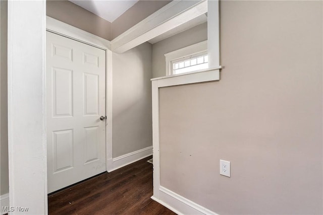 hall with wood finished floors and baseboards