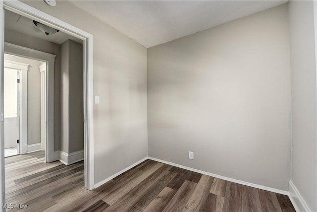 unfurnished room featuring dark wood finished floors and baseboards