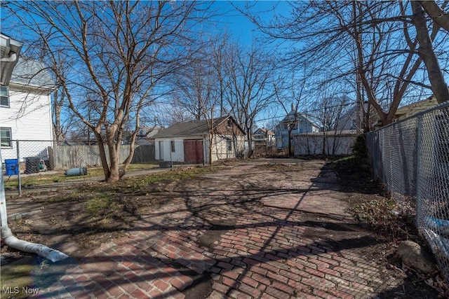 view of yard with an outdoor structure and a fenced backyard