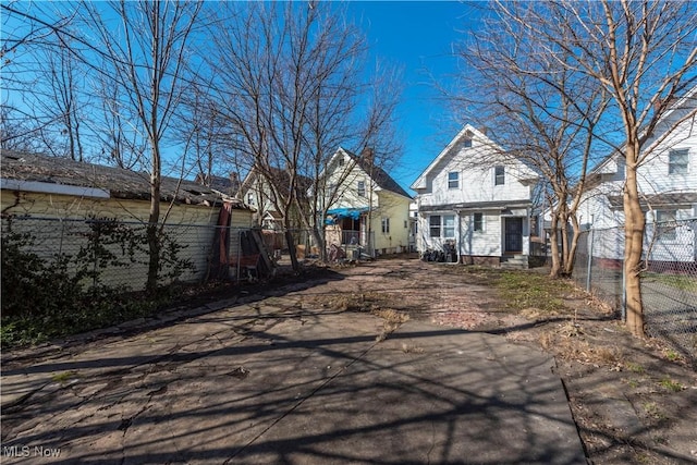 rear view of property featuring fence