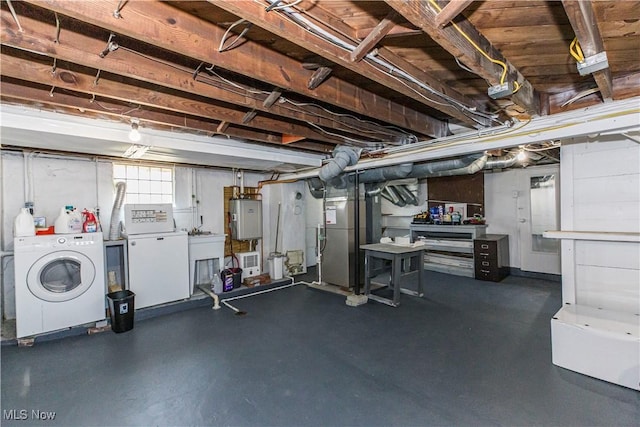 basement featuring washer and dryer, heating unit, refrigerator, and water heater