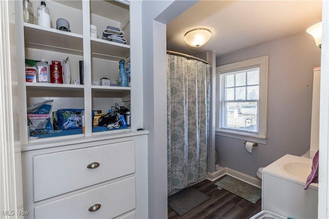 full bathroom with curtained shower, baseboards, toilet, wood finished floors, and vanity