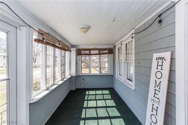 unfurnished sunroom with wooden ceiling