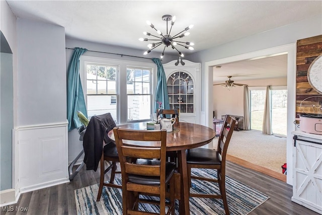 dining room featuring dark wood-type flooring and an inviting chandelier