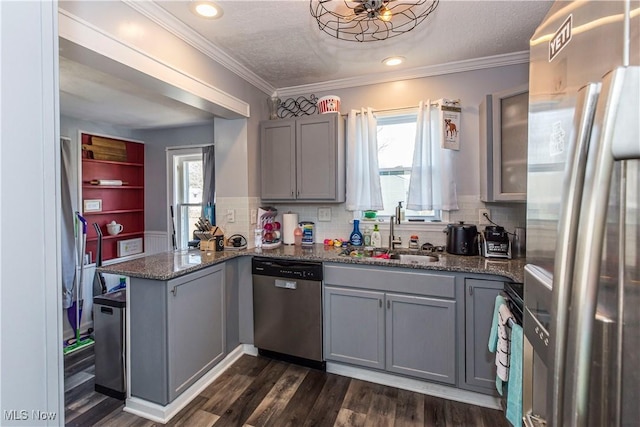 kitchen with a wealth of natural light, gray cabinets, stainless steel appliances, and a sink