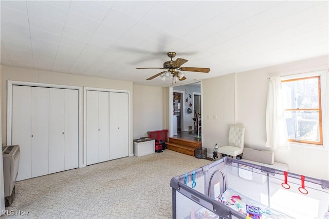 bedroom featuring two closets and ceiling fan