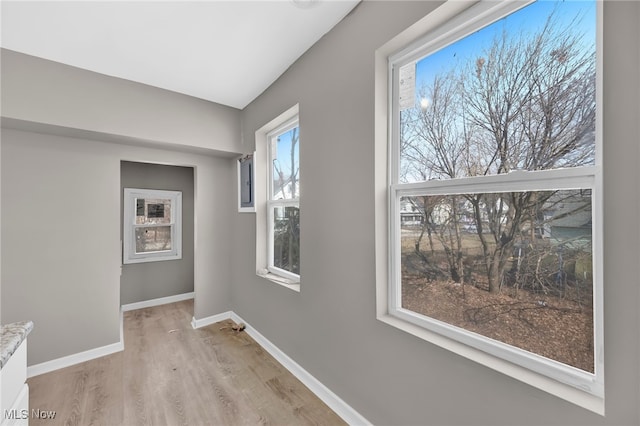 unfurnished room featuring light wood-style flooring and baseboards