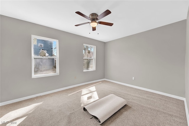 unfurnished room featuring baseboards, carpet floors, and ceiling fan