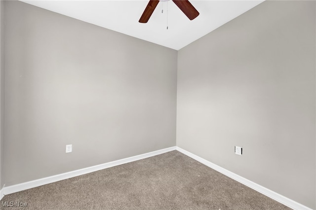 carpeted empty room with baseboards and a ceiling fan