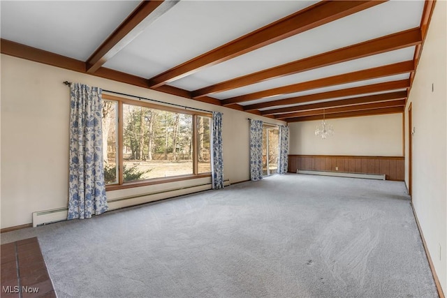 carpeted empty room featuring a baseboard heating unit, a chandelier, beam ceiling, baseboard heating, and wainscoting