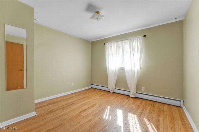 unfurnished room with light wood-style flooring, baseboards, and baseboard heating