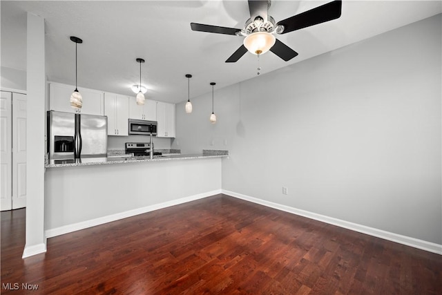 kitchen with dark wood-style floors, appliances with stainless steel finishes, baseboards, and a ceiling fan