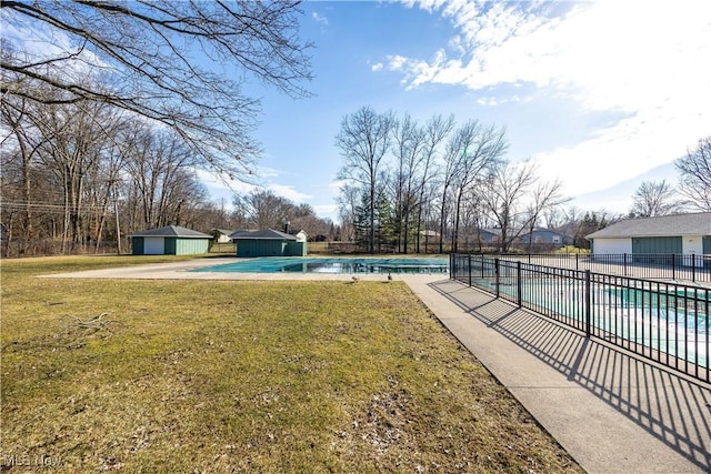 view of yard with a patio, an outdoor structure, a community pool, and fence