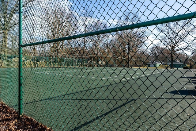 view of tennis court with fence