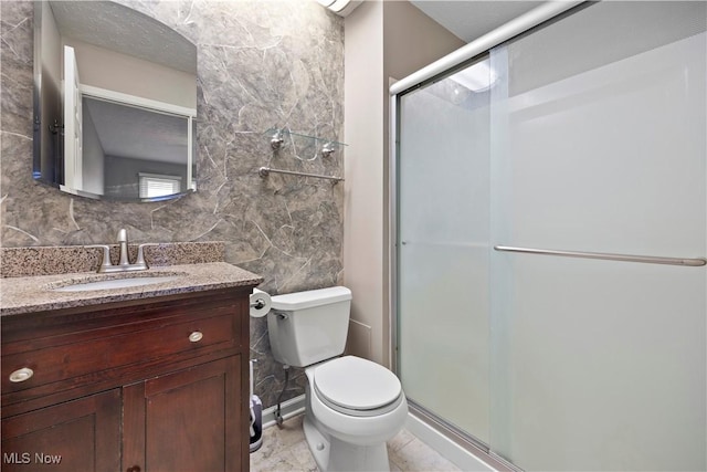 bathroom featuring vanity, decorative backsplash, a shower stall, tile walls, and toilet