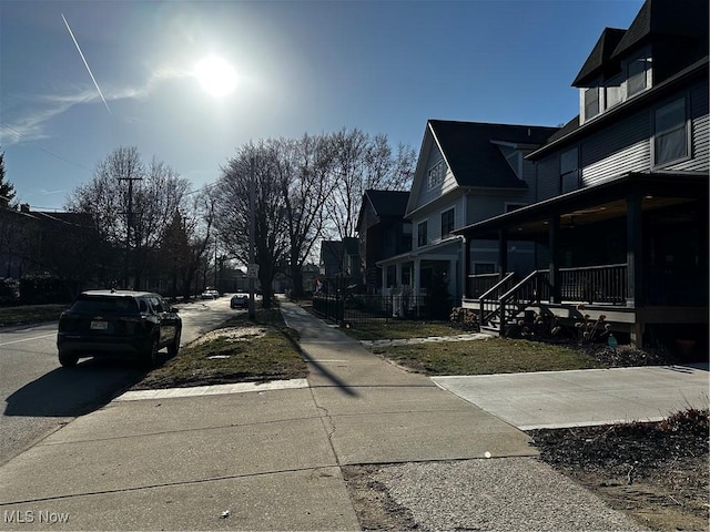 view of street with sidewalks and a residential view