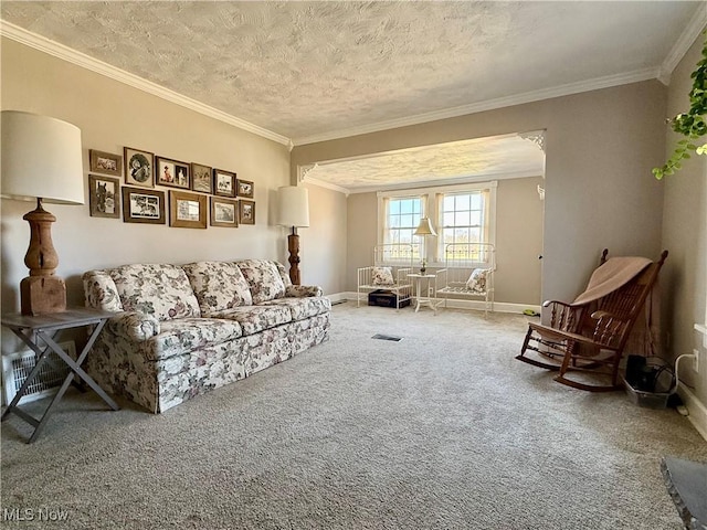 living room featuring visible vents, a textured ceiling, carpet, crown molding, and baseboards