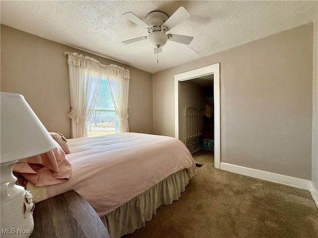 carpeted bedroom with baseboards, a textured ceiling, and a ceiling fan