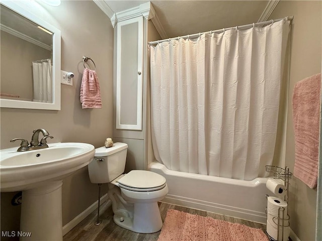 full bath featuring wood finished floors, a sink, ornamental molding, shower / bath combo with shower curtain, and toilet