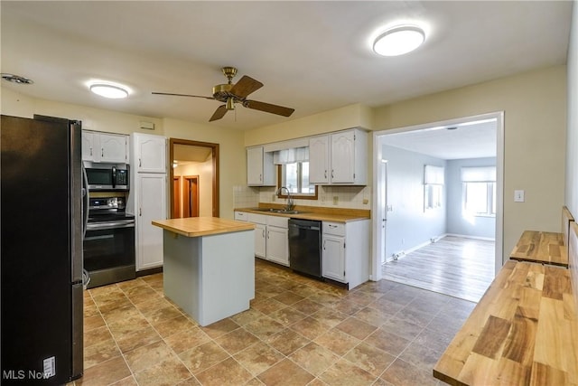 kitchen with wooden counters, a sink, ceiling fan, appliances with stainless steel finishes, and backsplash