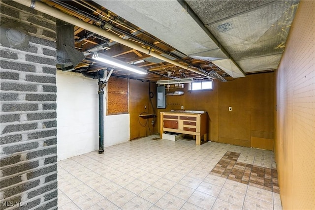 below grade area featuring electric panel and tile patterned floors