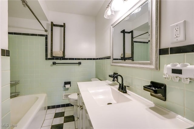 full bath featuring tile patterned floors, toilet, tile walls, and vanity