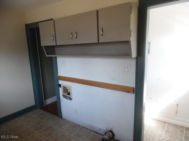 clothes washing area featuring cabinet space and hookup for a washing machine