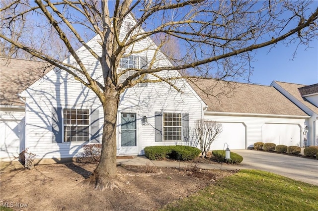 view of front of home featuring driveway, a shingled roof, and a garage