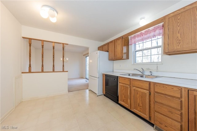 kitchen featuring a sink, freestanding refrigerator, brown cabinetry, light countertops, and dishwasher