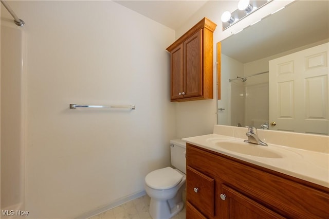 full bath with vanity, toilet, baseboards, and walk in shower