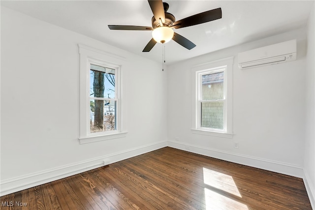 unfurnished room featuring ceiling fan, an AC wall unit, baseboards, and dark wood-style flooring