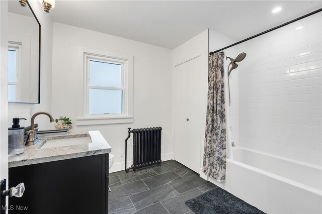 bathroom with vanity, baseboards, radiator heating unit, shower / bath combination with curtain, and toilet