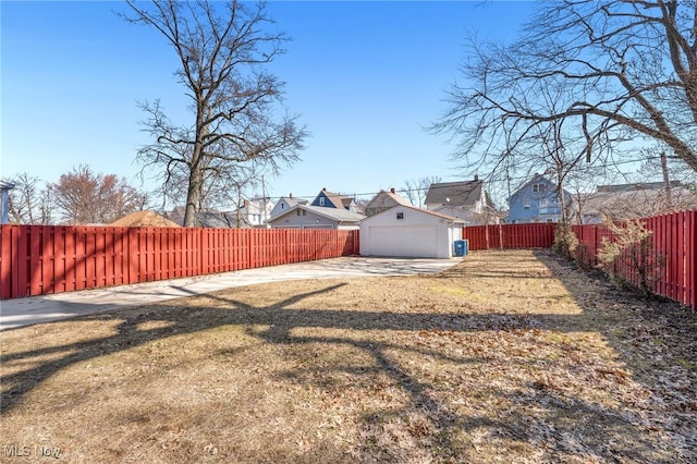 view of yard with driveway and a fenced backyard