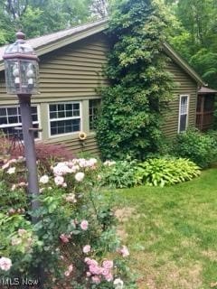 view of side of home featuring a lawn