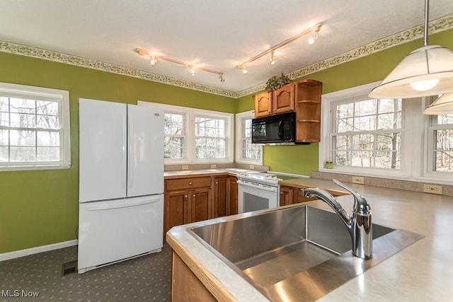 kitchen featuring a sink, brown cabinets, white appliances, and open shelves