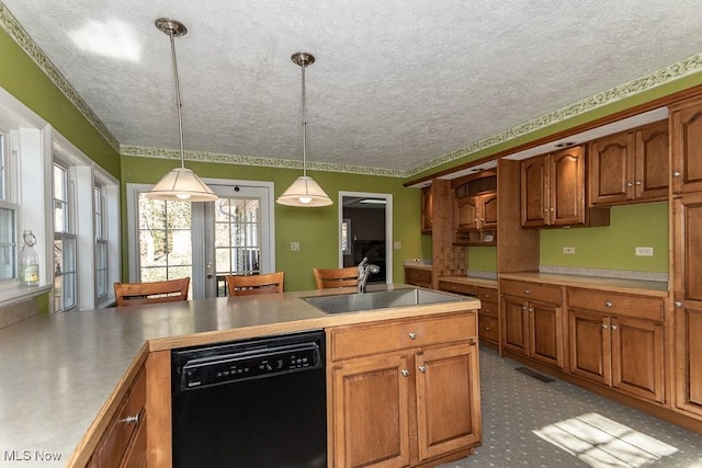 kitchen featuring decorative light fixtures, dishwasher, brown cabinetry, a textured ceiling, and a sink