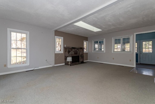 unfurnished living room with baseboards and carpet