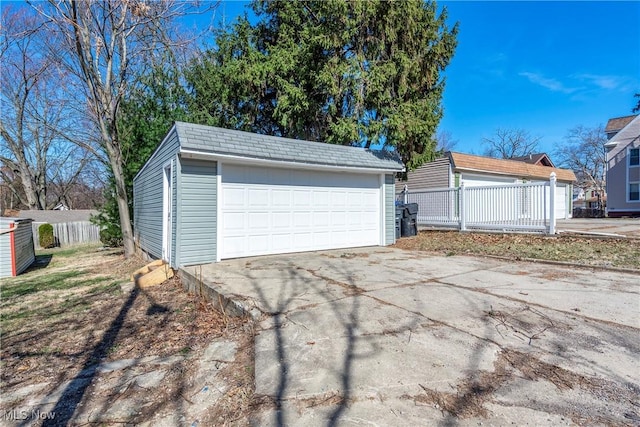 detached garage featuring fence