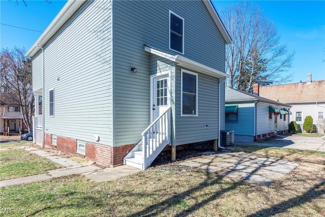 rear view of property with central AC unit and entry steps